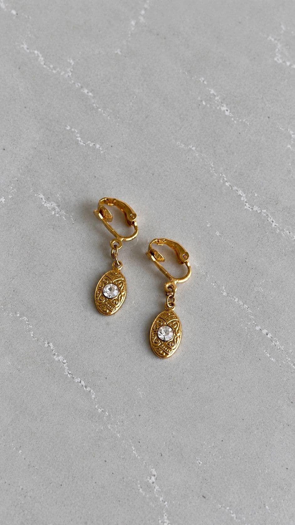 Ornamental gold tone earrings